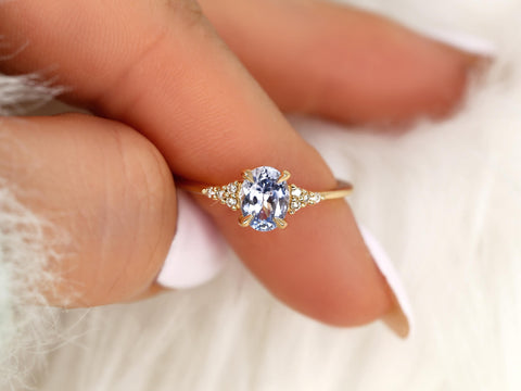oval cornflower lilac sapphire cluster ring with dainty diamonds held on pointer and thumb
