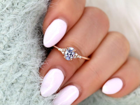 oval cluster sapphire ring with lavender sapphire in rose gold on middle finger