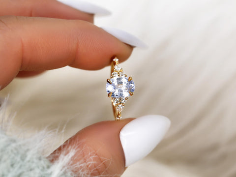 frosted lavender cornflower sapphire oval cluster ring in 14kt gold on pinched finger