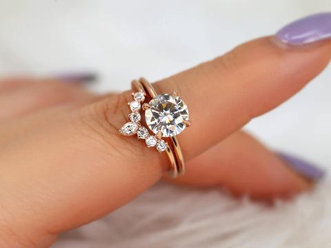 round solitaire moissanite paired with a unique diamond nesting band in 14kt rose gold on pointer finger