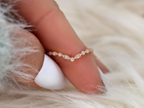 scalloped chevron diamond band with milgrain detail on finger in rose gold