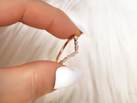 dainty chevron diamond ring with vintage detail pinching between fingers