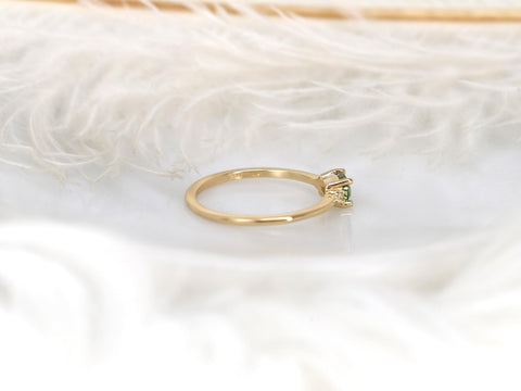 oval green sapphire ring in trilogy style with two diamonds on yellow gold on white background back view