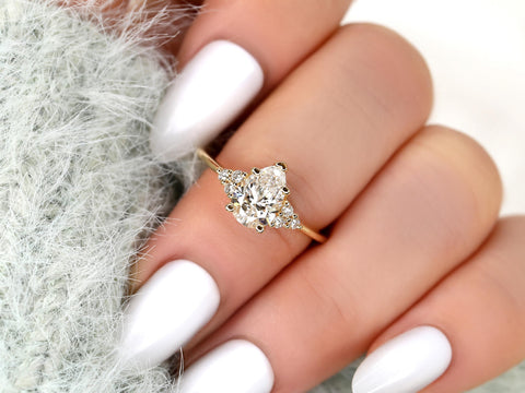 pear cut diamond ring with cluster diamonds on middle finger