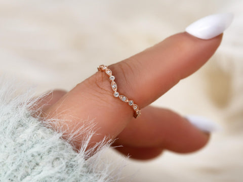 chevron dainty diamond band with art deco on pointer finger in rose gold